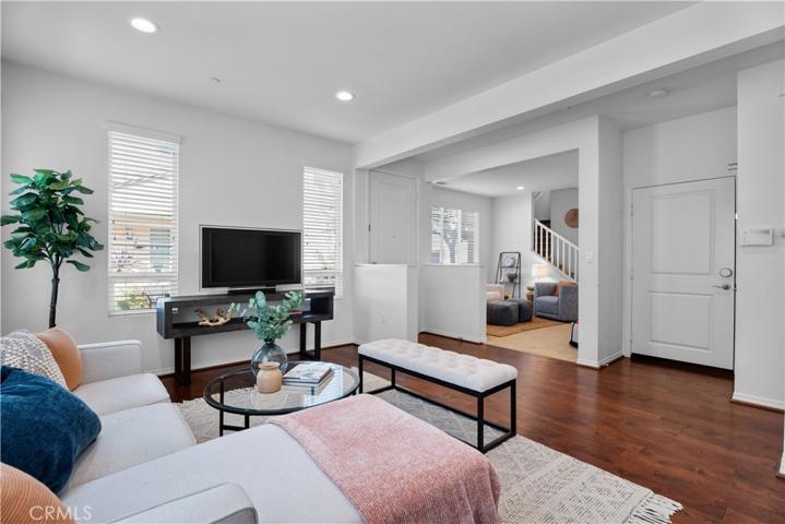Light and bright open floor plan with engineered hardwood floors, living room and adjoining family room/multi-use area.