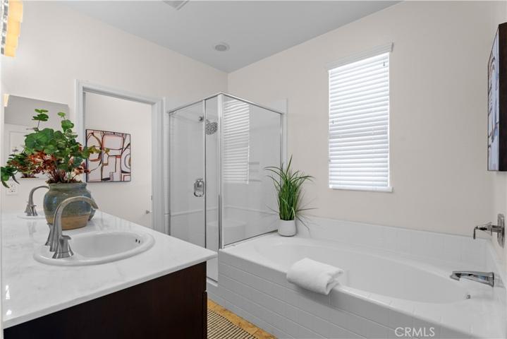 En-suite primary bathroom with dual sinks, separate tub and shower.