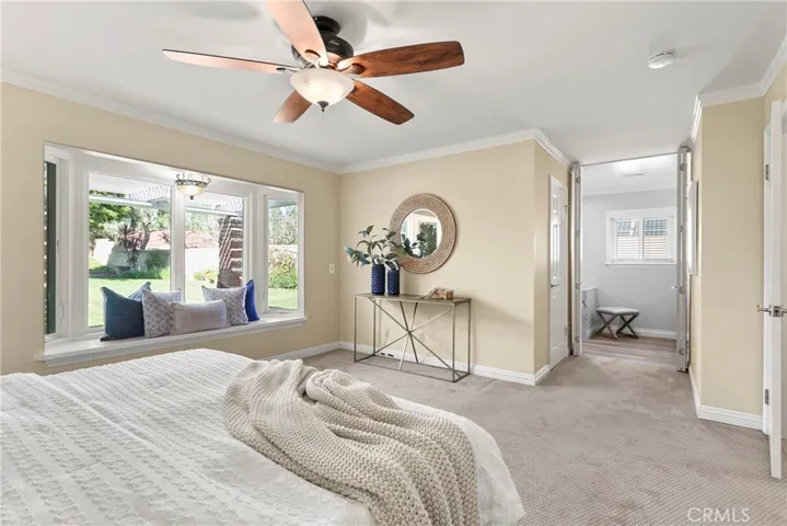 Light filled primary bedroom with a walk in closet.