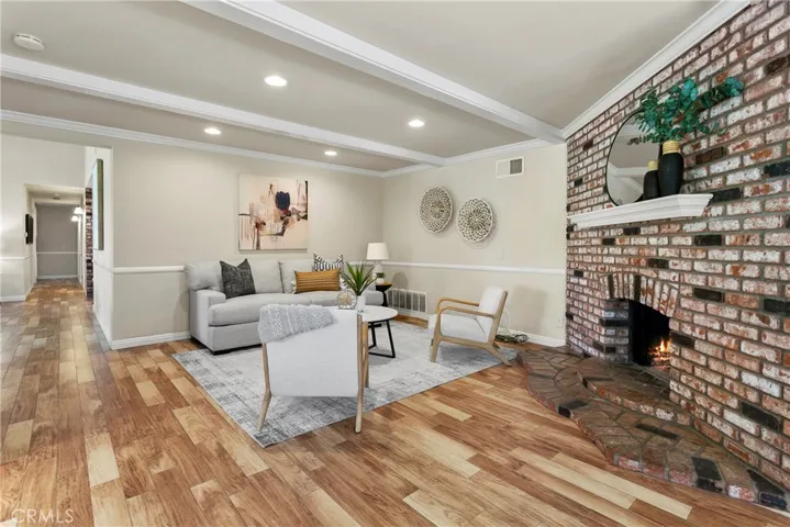 Recessed lighting, hardwood flooring and a warm and inviting fireplace to relax