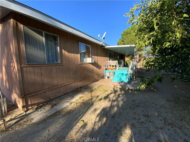 The covered patio has a spacious deck with stairs on one side and a ramp on the opposite side.