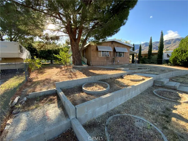 You will love the picturesque mountains and hills that surround this property.  The front yard has a great walkway to the home and beautiful planters ready for your gardening imagination.