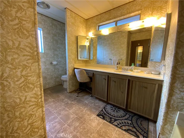 Large main bath includes a vanity, lots of storage, and a tub.
