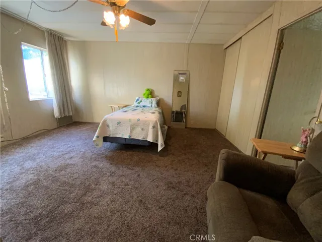 View 2 of the spacious main bedroom with two big windows that let in lots of natural light.