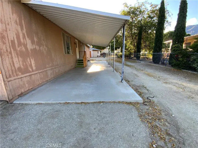 A nice covered carport with a concrete driveway will allow you or your guests to pull right up to the home's back door entrance for those rainy days/nights.