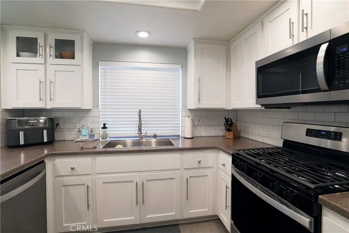 Kitchen sink, microwave, washing machine and stove