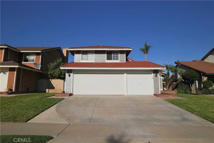 Front, daytime. 3 car garage