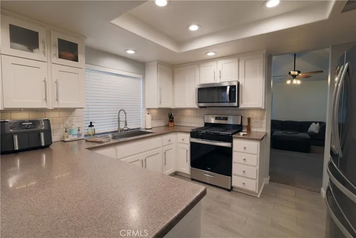 Full kitchen in evening with under cabinet lighting