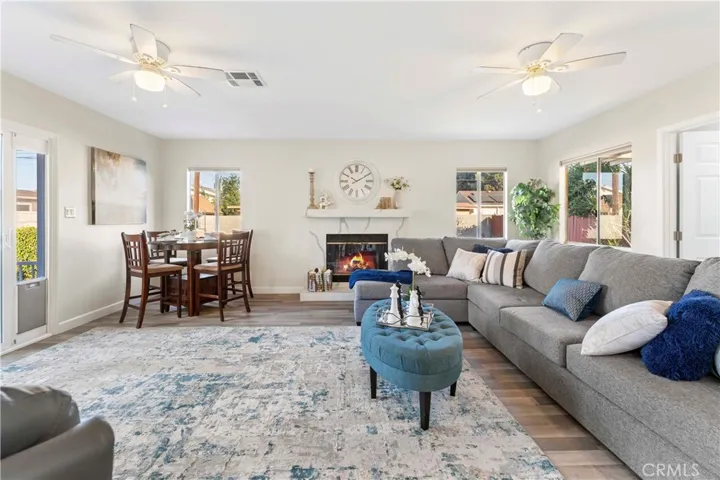 Isn't this just lovely? the family/dining that opens up from the kitchen area. The fireplace has quartz counters consistent with the kitchen tying it in together beautifully.