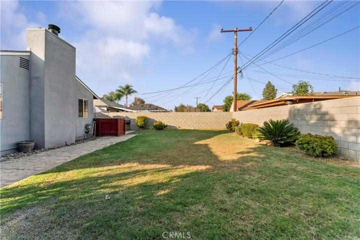 Spacious backyard with block walls.