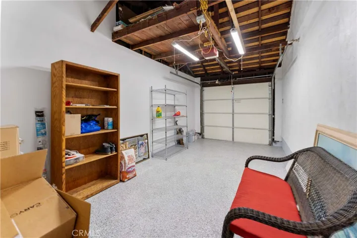 Clean garage with finished walls and epoxy flooring.