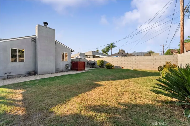 Spacious backyard with block walls.