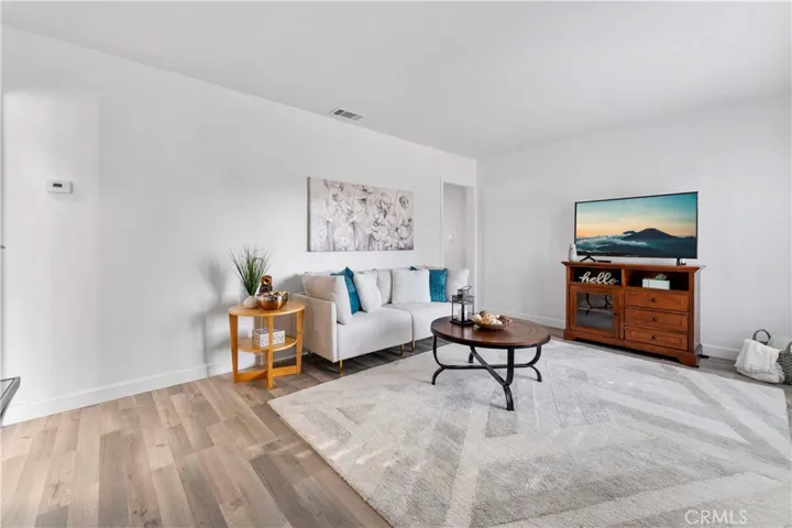 Formal living lovingly updated with luxury vinyl plank flooring and double pane windows and door/screen door and paint.
