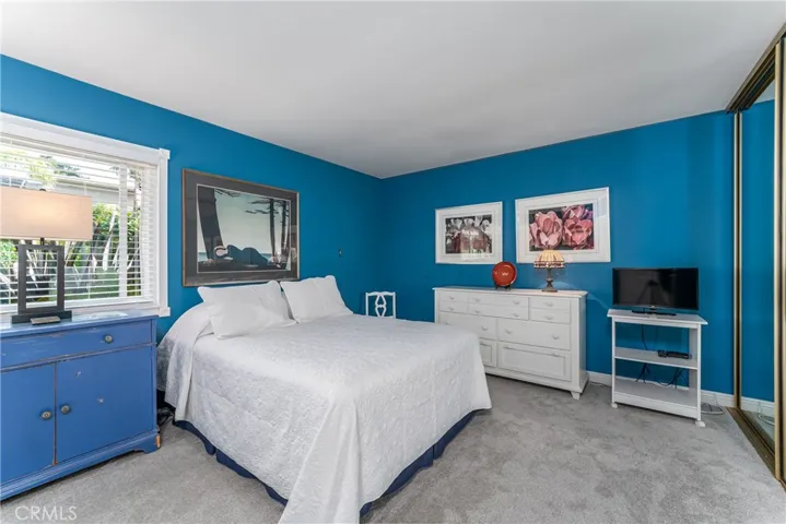 Primary suite with a wall of closets and beautiful newer bathroom with walk in shower.