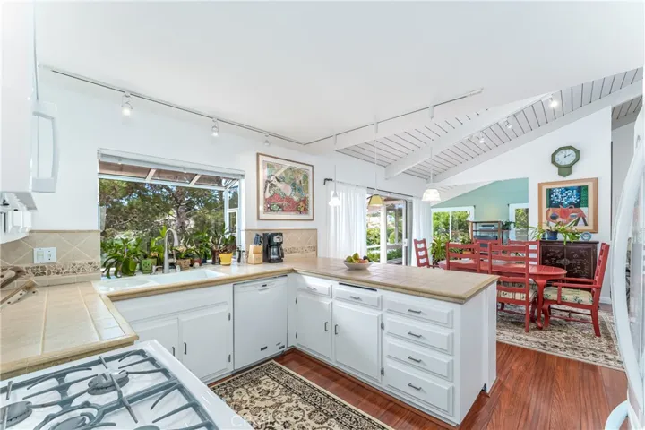 Open kitchen with gas range and window over the sink with great views.
