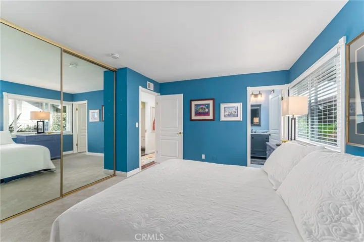 Primary suite with a wall of closets and beautiful newer bathroom with walk in shower.