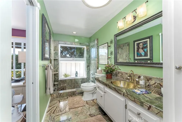 Secondary bathroom has access from both the hallway and second bedroom. This bath can easily accomodate a dual sink vanity.