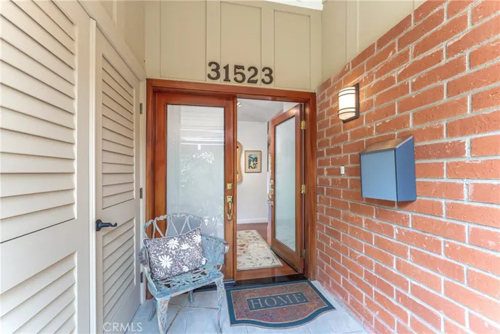 Fornt porch leads you to double door entry.