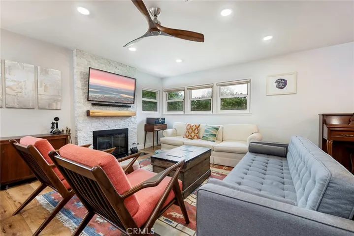 Beautiful family room with recessed lighting, LVT floors and modern fireplace.