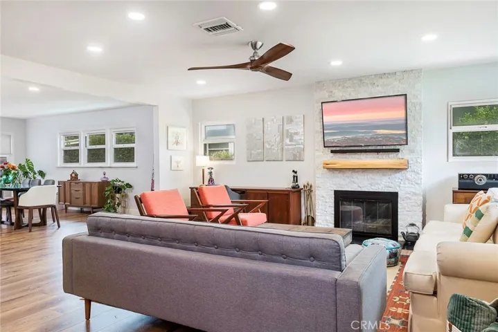 Beautiful family room with recessed lighting, LVT floors and modern fireplace.