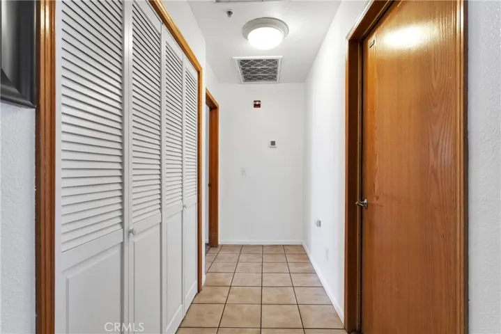 Hallway to garage and primary bedroom