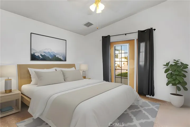 Guest bedroom 2 with French door leading to backyard