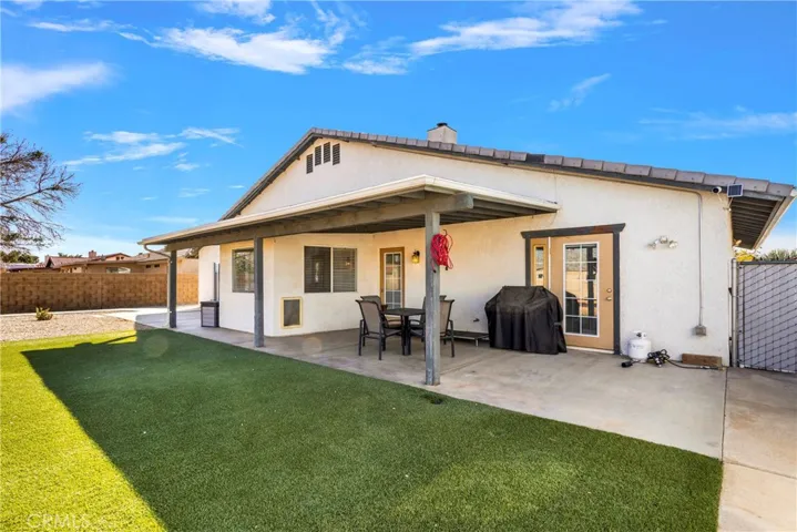 Backyard patio and artificial grass