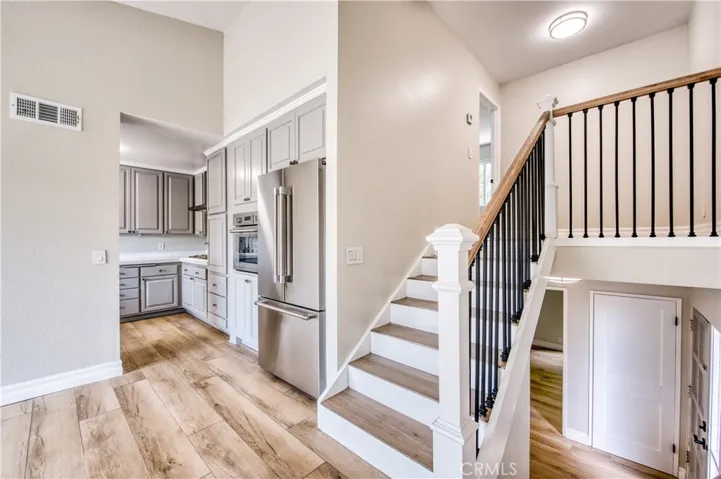 Living room with stairs to primary bedroom