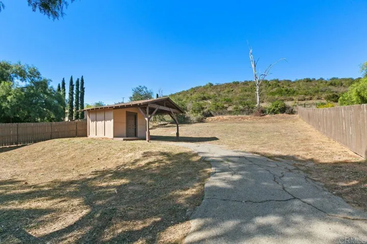 This is the exterior back showing the back yard and the large bonus space above, roughly 60'x100'.