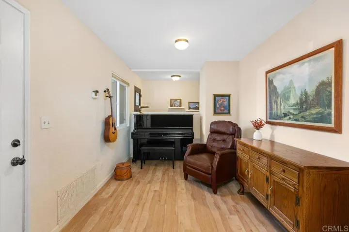 This would be the dining room, currently used as a music or hobby room.