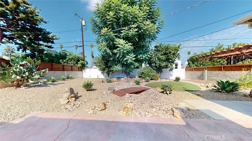 View of backyard from door into back of garage.