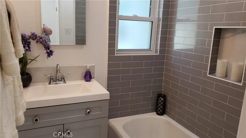 Lovely new tile with a nook for shampoo, etc.