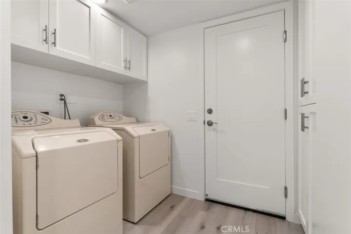 The laundry room features custom cabinets.