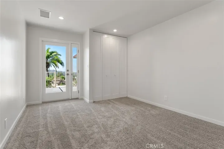 The first guest room features a French door with an opening screen-vented sidelite and balcony.