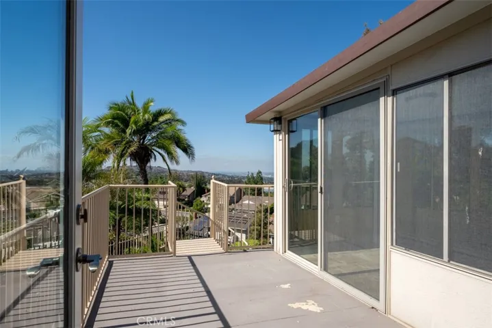 The balcony off the first guest room and primary room office.