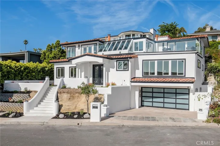 Discover the pinnacle of Laguna Beach living at this exceptionally bright and spacious ocean-view custom home in the sought-after Top of the World community.