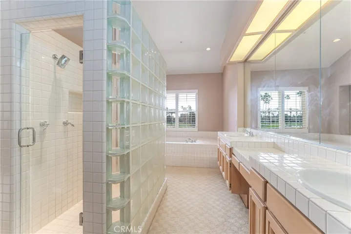 Luxurious primary bathroom with Roman style soaking tub with incredible views