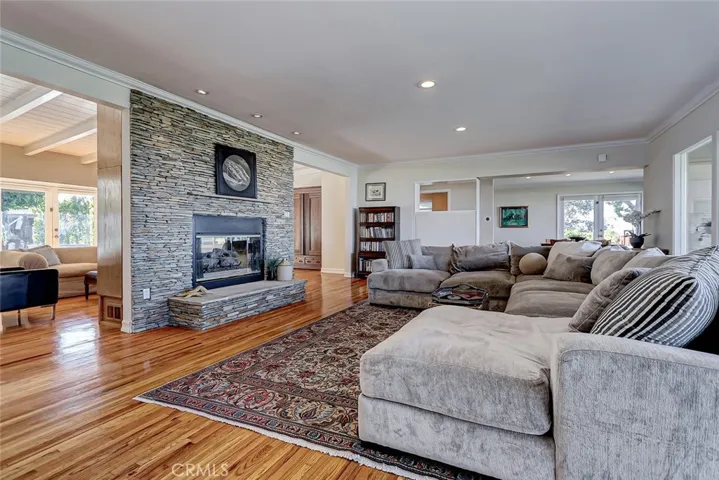 Open great room with double sided stacked stone fireplace
