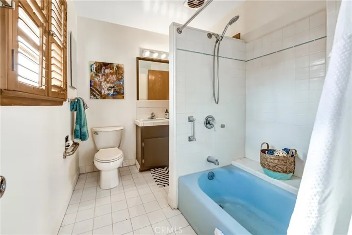 NEW TOILET AND NEWLY PAINTED VANITY AND FRAMED MIRROR