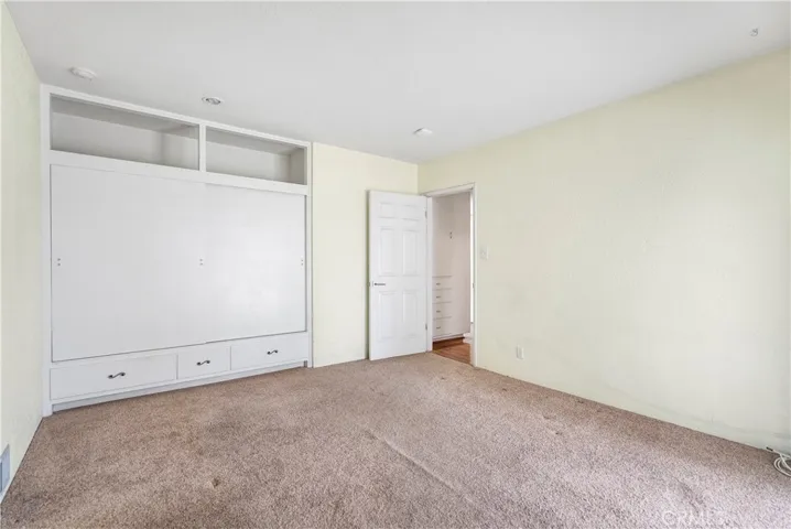 Alternate view of Bedroom #3 with large closet -- seller removed top doors and placed wicker storage baskets for practical and aesthetic purposes.