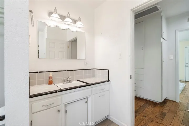 Hallway bathroom with vintage tile on bathroom sink in excellent condition.