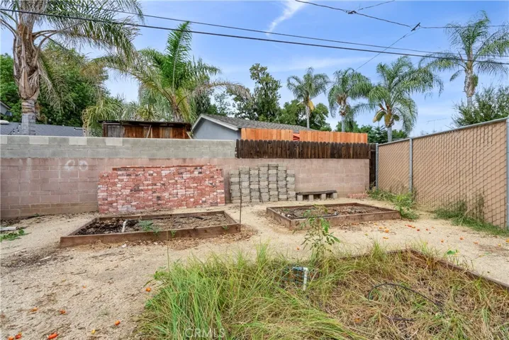 Raised garden beds can be removed to make extra space for RV parking and/or ADU... or enlarge the garage. So many possibilities. Bricks and pavers included.