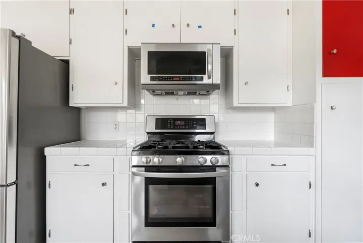 Stainless steel gas stove and built-in microwave included.