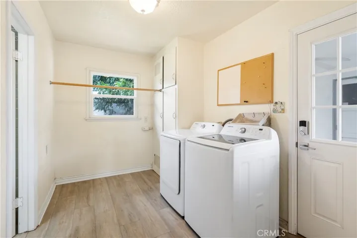 Laundry room (washer and dryer included) with doorway to covered breezeway which leads to the garage.
