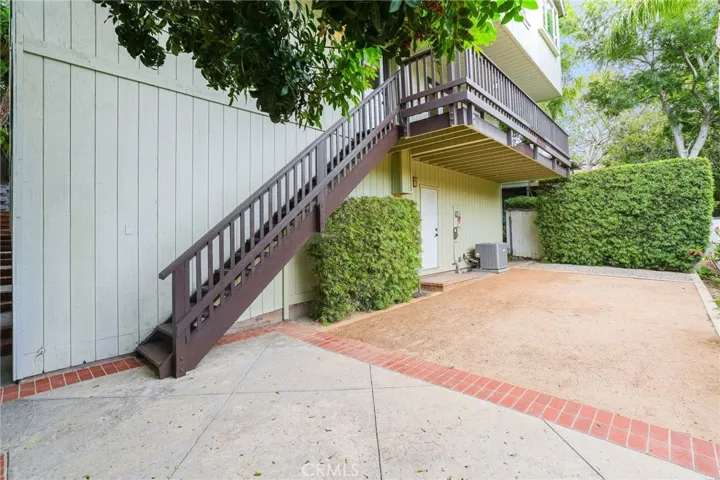 The door in the middle of the yard accesses a tall under-house space with future potential.