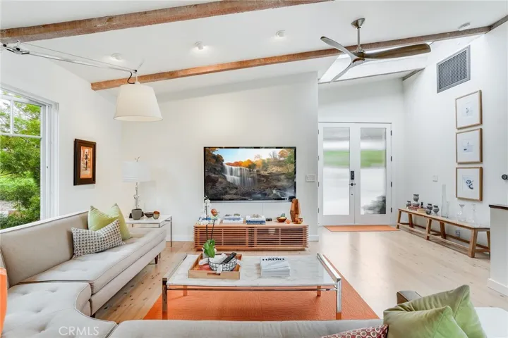 The living room is oversized, with two sets of French doors leading to the rear Ipe wood deck and two separate areas set to accommodate a large television for flexibility.
