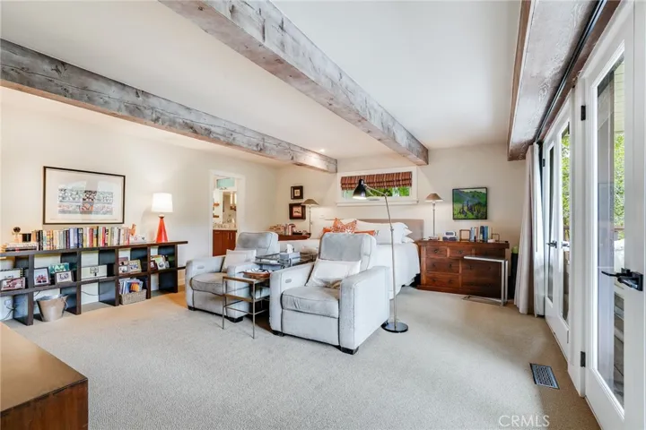 The primary suite is positively monstrous, with dual French doors granting hillside views and access to a second ipe wood deck.