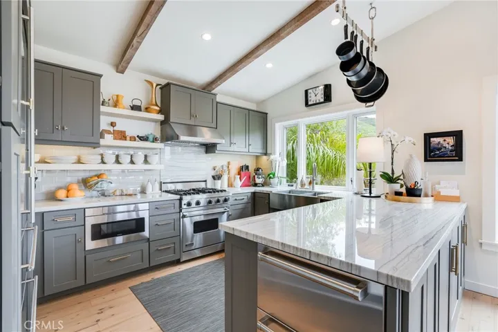 The spacious feeling is amplified by the towering cathedral ceilings. The kitchen includes a Viking stove with convection oven, Sharp drawer microwave, and direct access to the garage with no steps - easy grocery unload!
