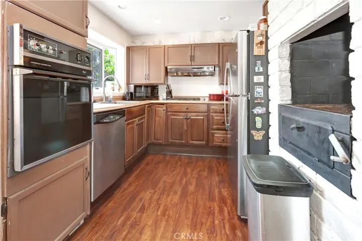 Kitchen with Beautiful Garden Window, New Stainless Gas Stove top and SS Hood, SS Sink and dishwasher (new) Electric Oven and built in BBQ built w/newer cabinetry and garden kitchen window.over sink