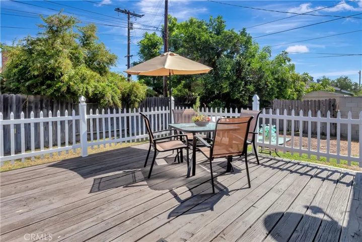 Backyard Deck with wood that is guaranteed for the life of the deck.  Enjoy your times in this large backyard.  Great for privacy.  Sprinklers front and back.